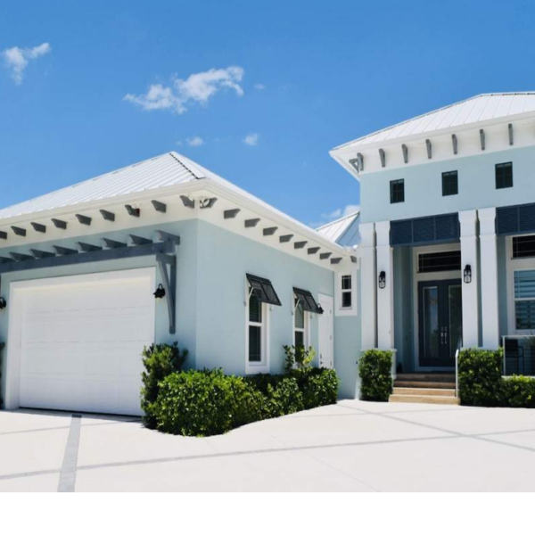 Custom black Bahama shutters installed on a luxury coastal Florida home, providing shade, privacy, and architectural curb appeal.