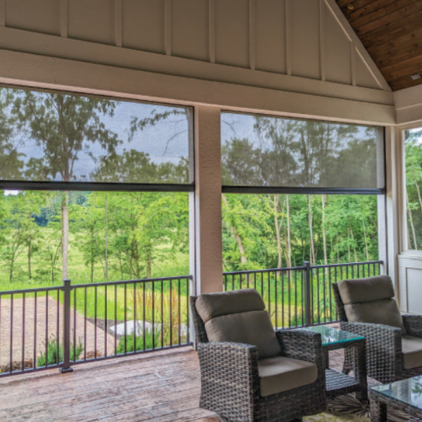 Motorized screens installed on a covered porch, providing shade, privacy, and insect protection while preserving scenic backyard views.